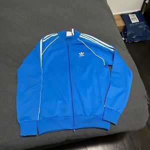 Blue Adidas sports jacket.